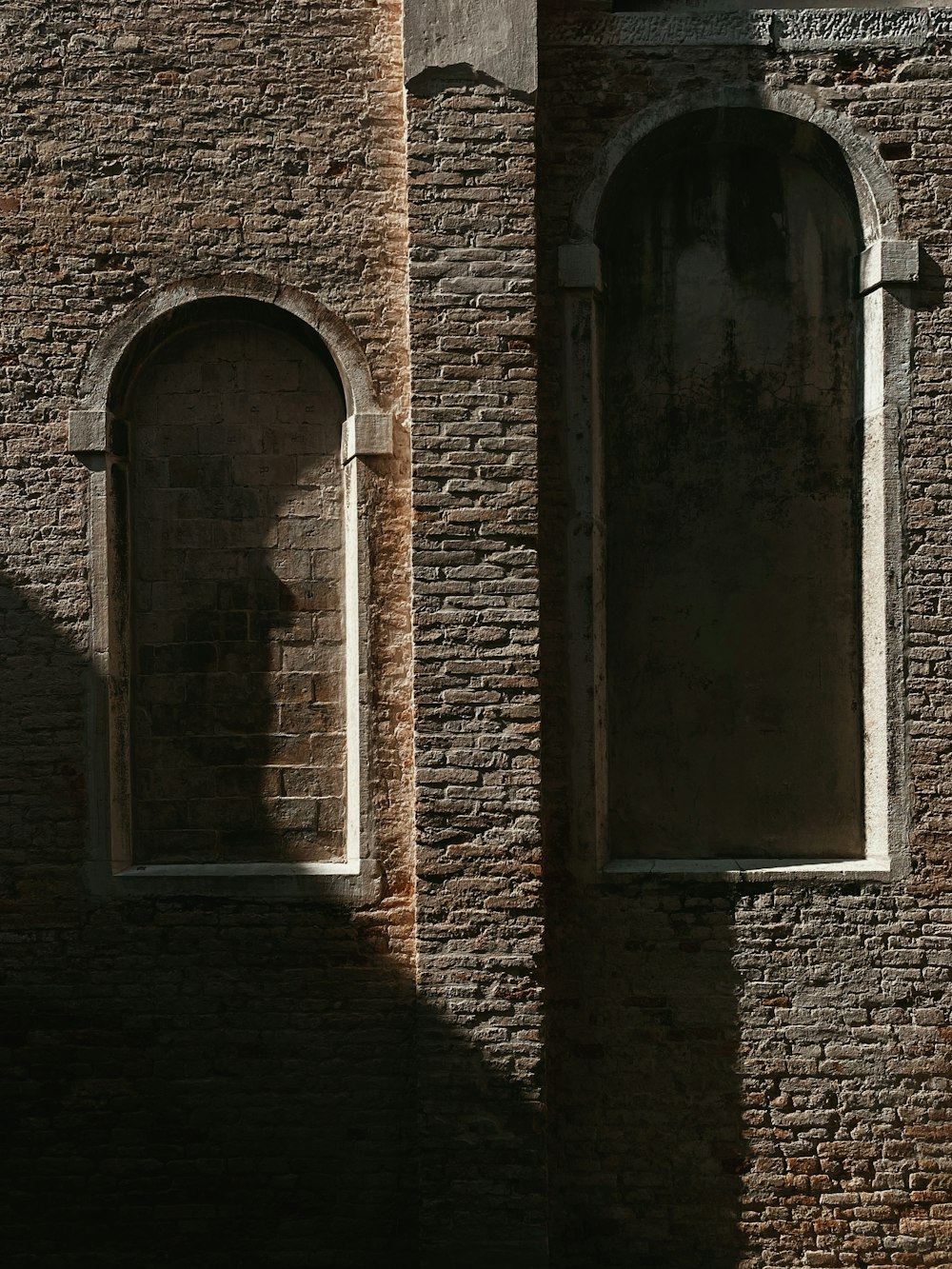 a person standing in front of a brick building