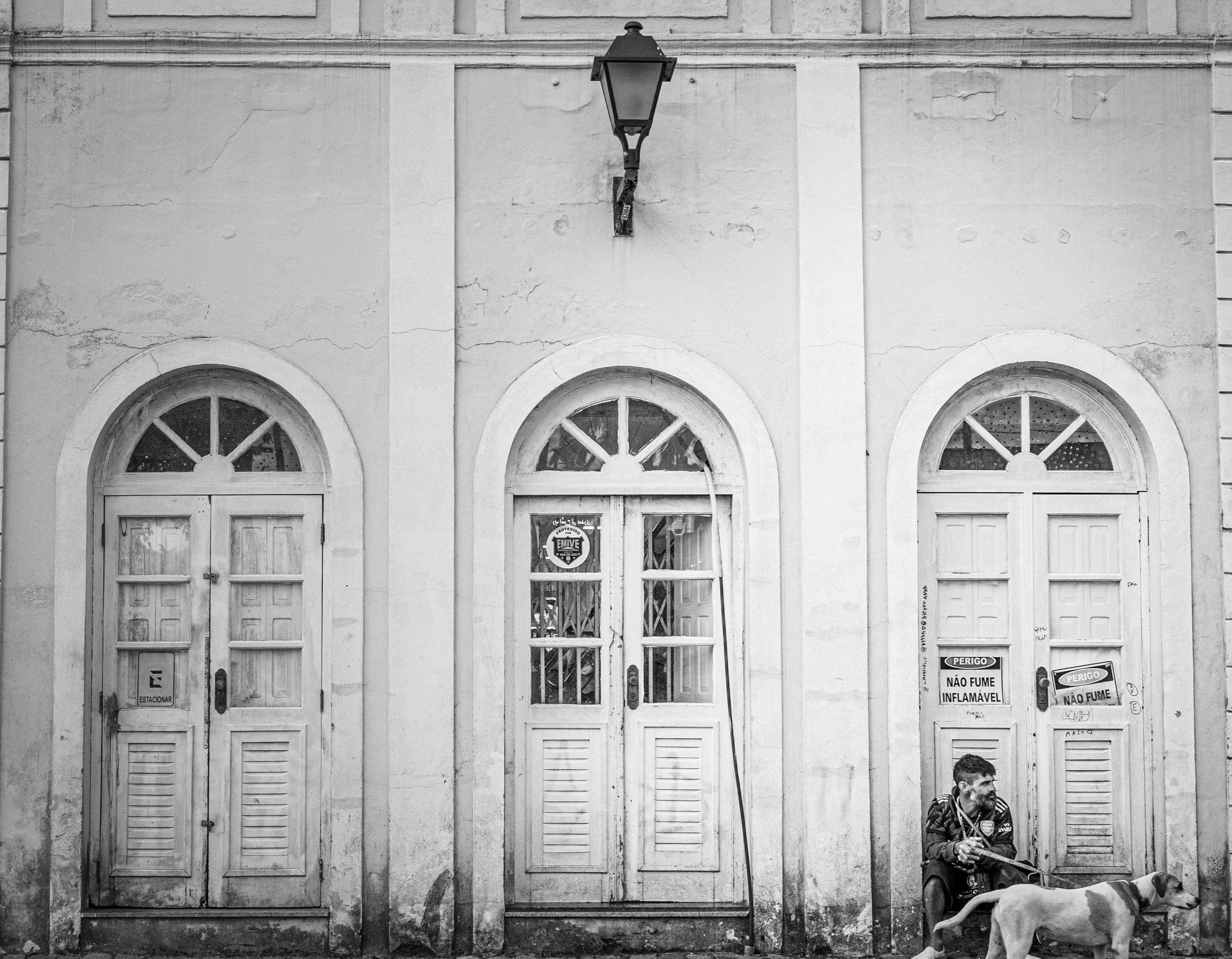 a man sitting on a bench next to a dog
