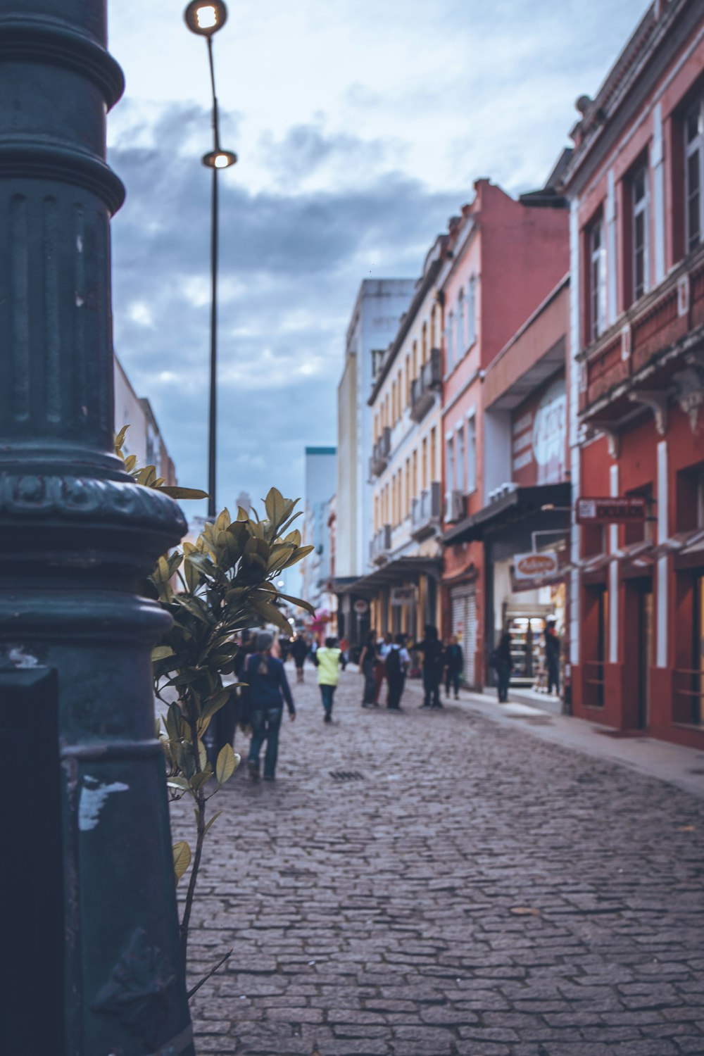 a street scene with people walking on the sidewalk