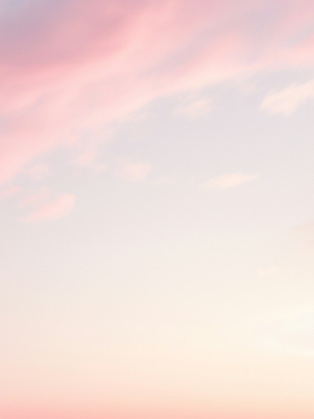 a couple of people standing on top of a sandy beach