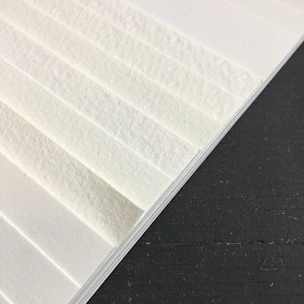 Close-up of a soft, white absorbent pad paper with textured surface.