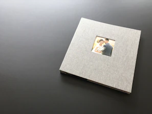 Elegant wedding album spread open, showcasing timeless cinematic frames