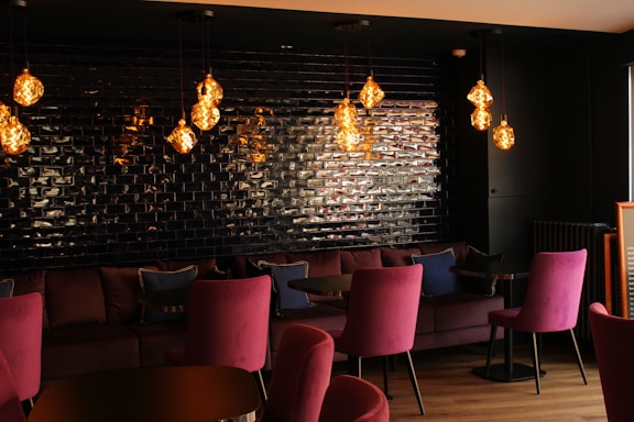 Cozy furniture showroom corner with deep purple walls and warm orange accents.