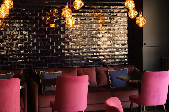 A cozy, stylish lounge interior with warm lighting and comfortable seating.