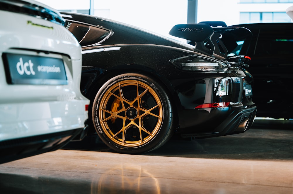 two cars parked next to each other in a garage