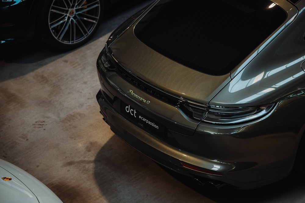 a silver car parked in a garage next to other cars