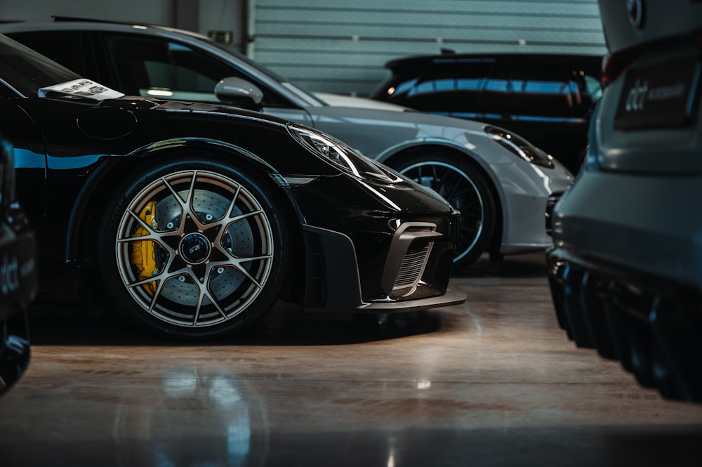 a couple of cars parked next to each other in a garage