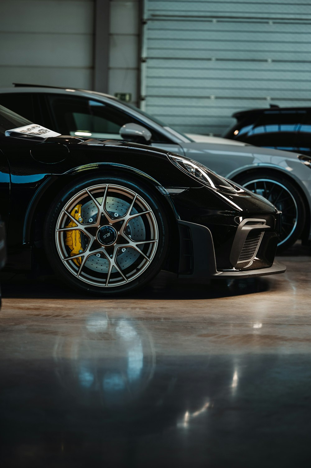 a black sports car parked in a garage