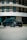 A luxurious car parked in front of a modern building, showcasing its elegance.