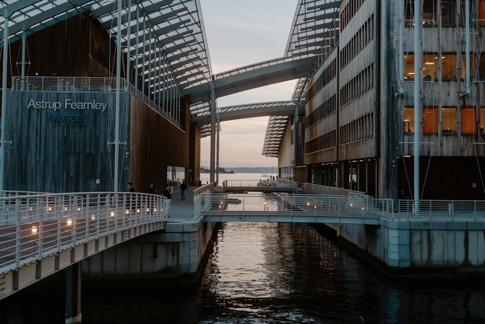 a bridge over a body of water with a building in the background