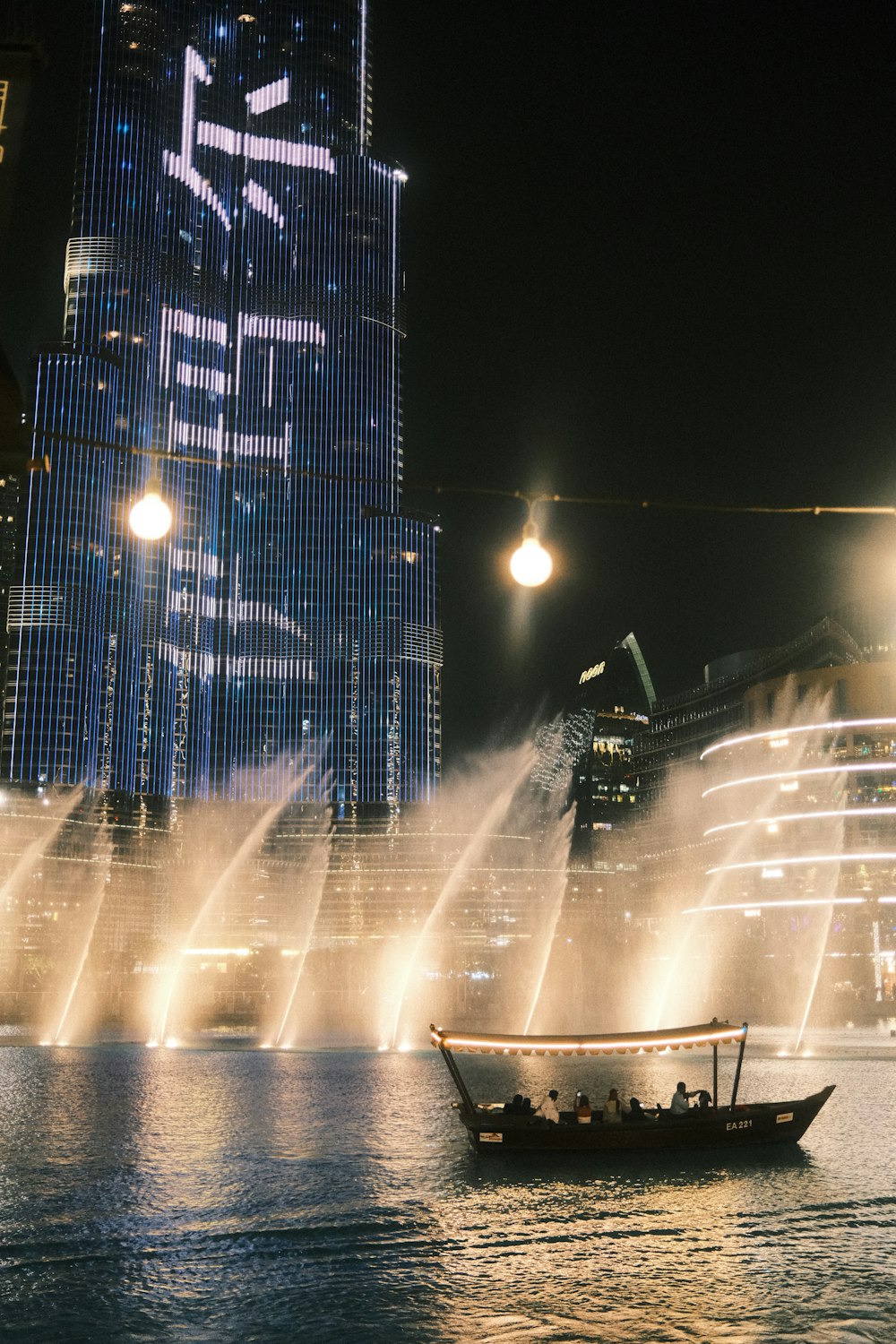 a boat in a body of water near a tall building