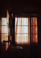 A cozy bathroom scene featuring a soft anti-slip mat and a sheer curtain gently swaying in natural light.
