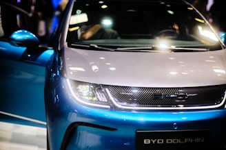 a close up of the front of a blue and white car
