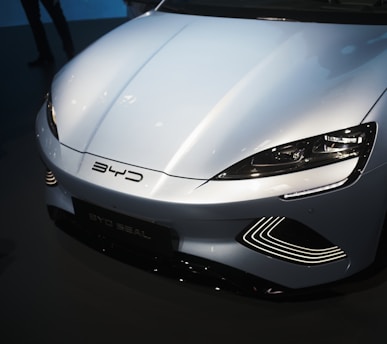 a white sports car is on display at a car show