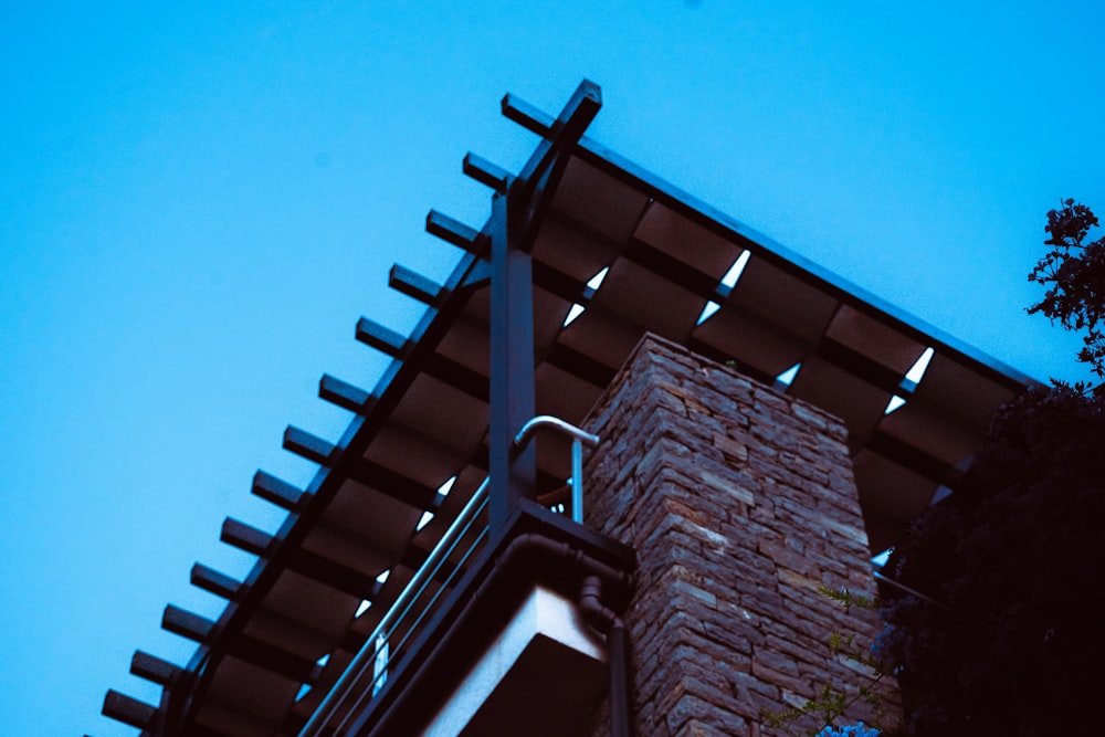 a tall brick building with a sky background