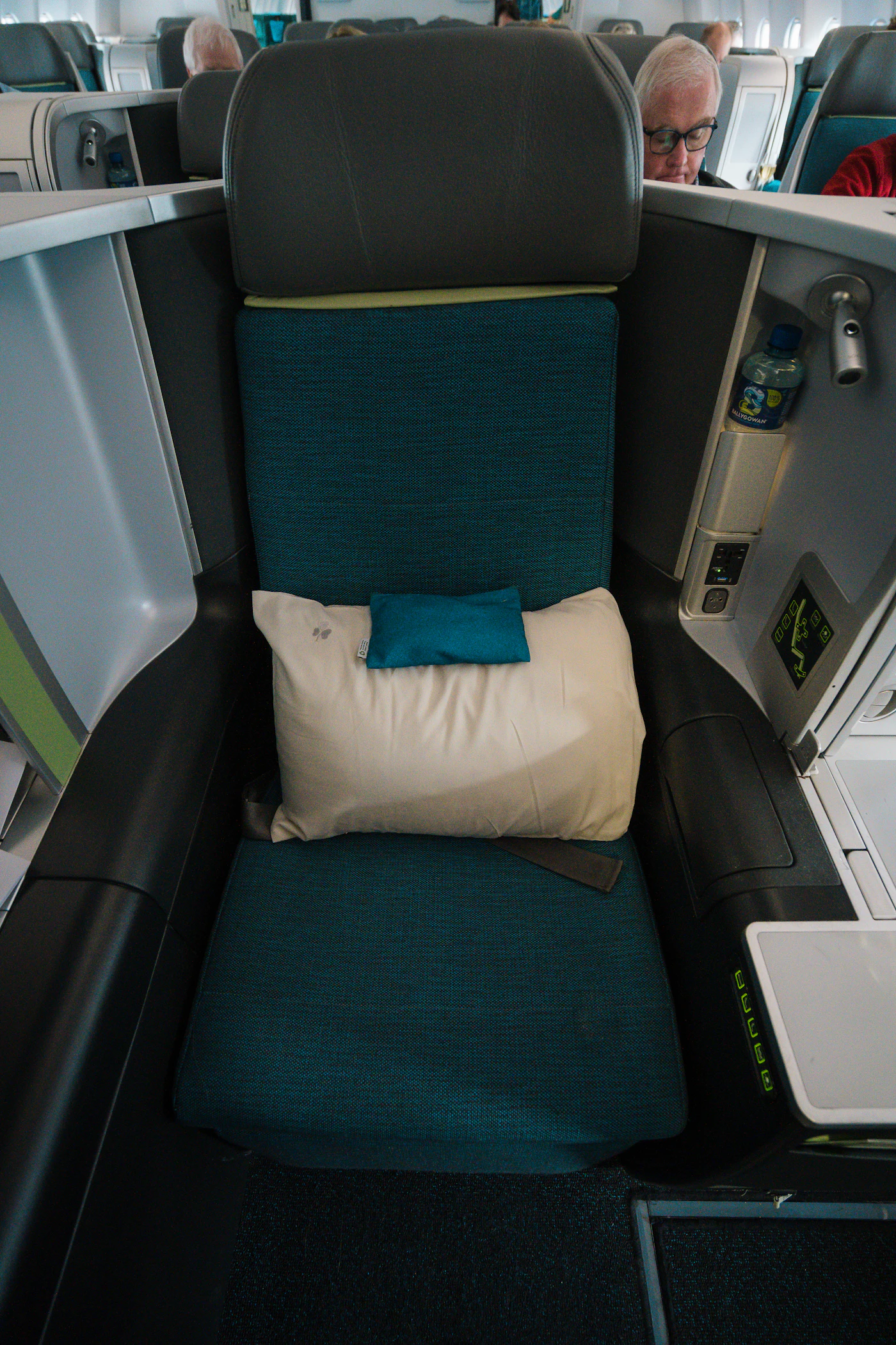 Airplane seat prepared with a travel pillow for added comfort