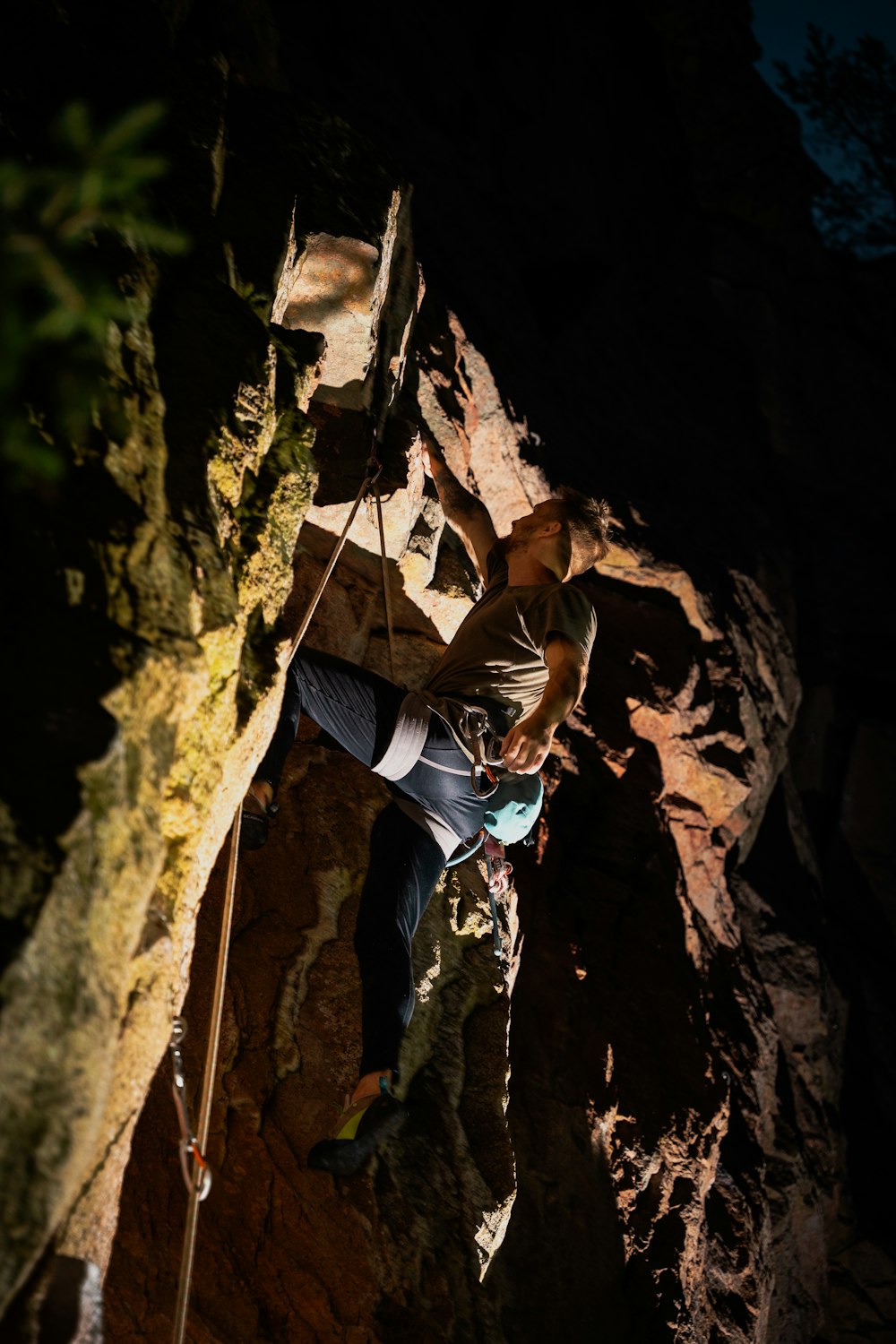 a man climbing up the side of a mountain