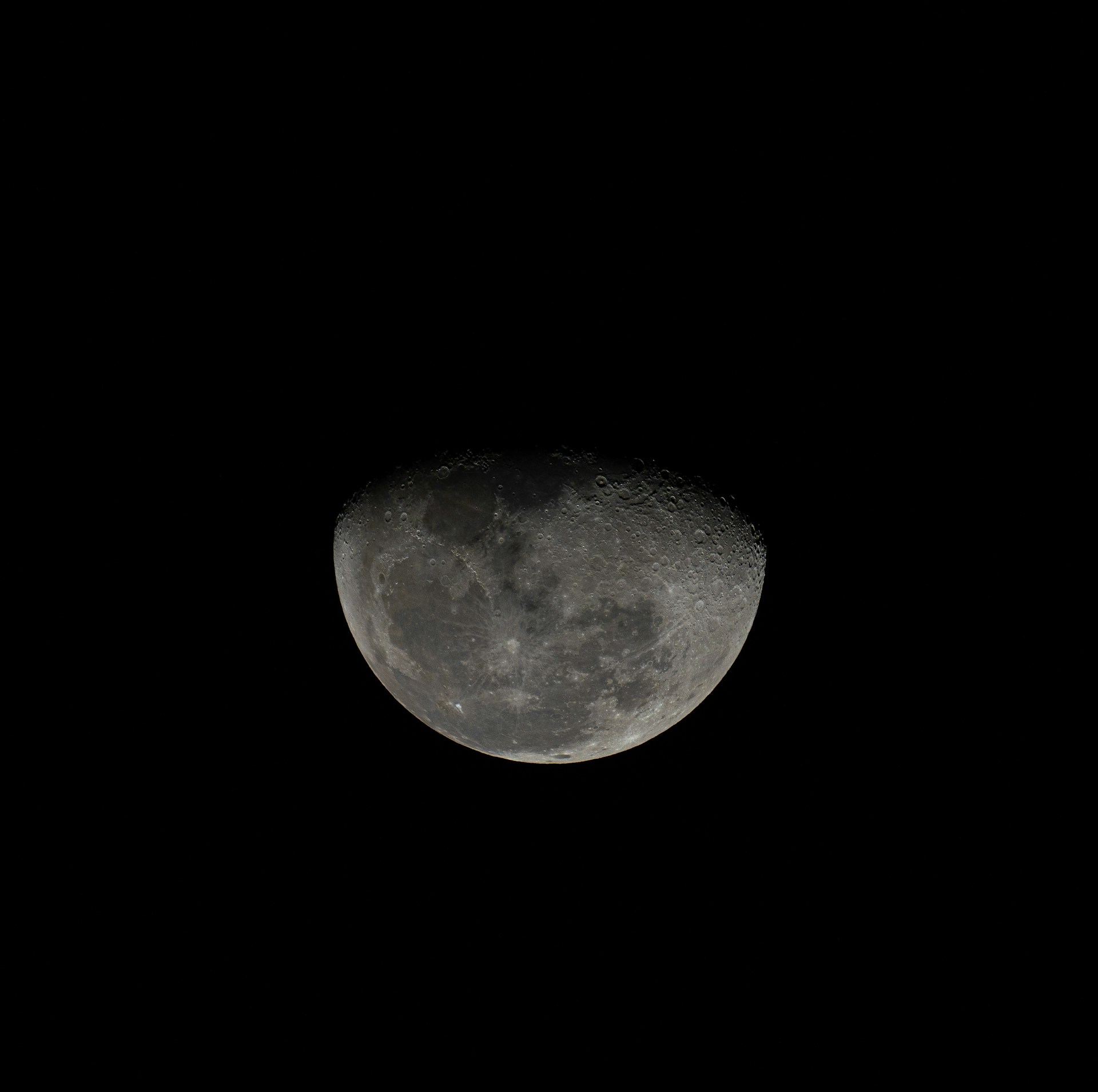a full moon in the sky with a black background