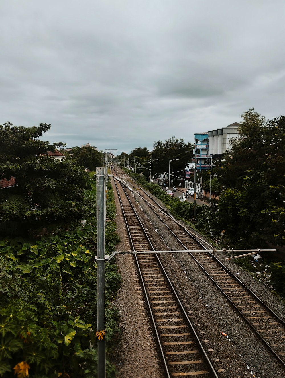 a view of a train track from the top of a hill