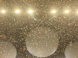 Happy players celebrating their wins with golden confetti in the background.