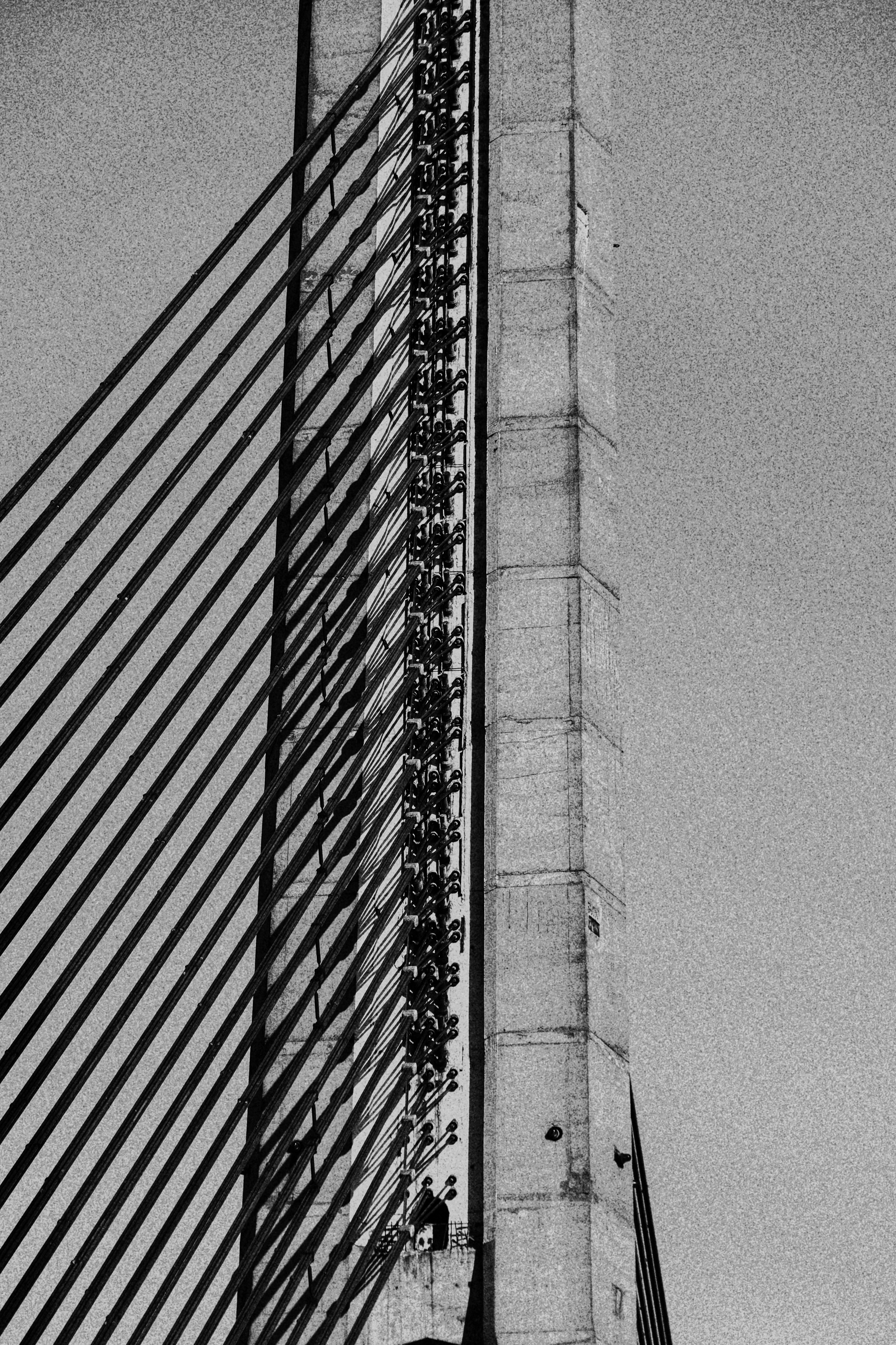 Close-up aerial view of bridge cable anchorage and deck structure