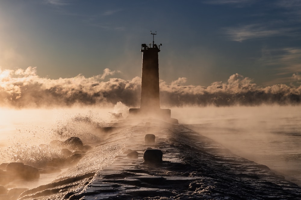 a lighthouse in the middle of a body of water