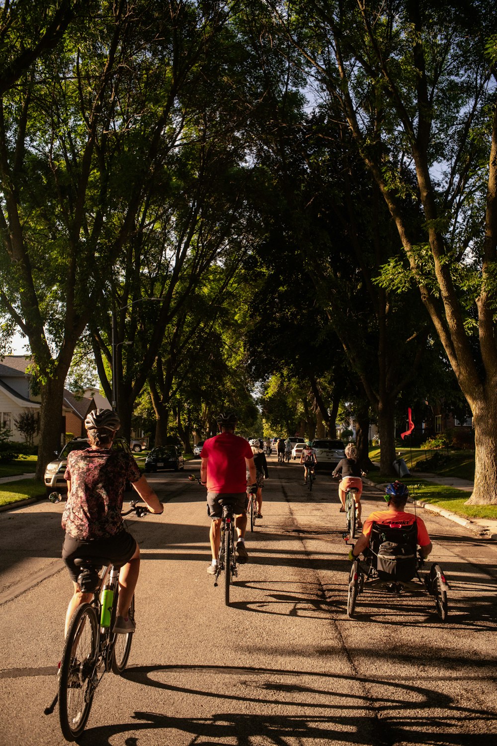 a group of people riding bikes down a street