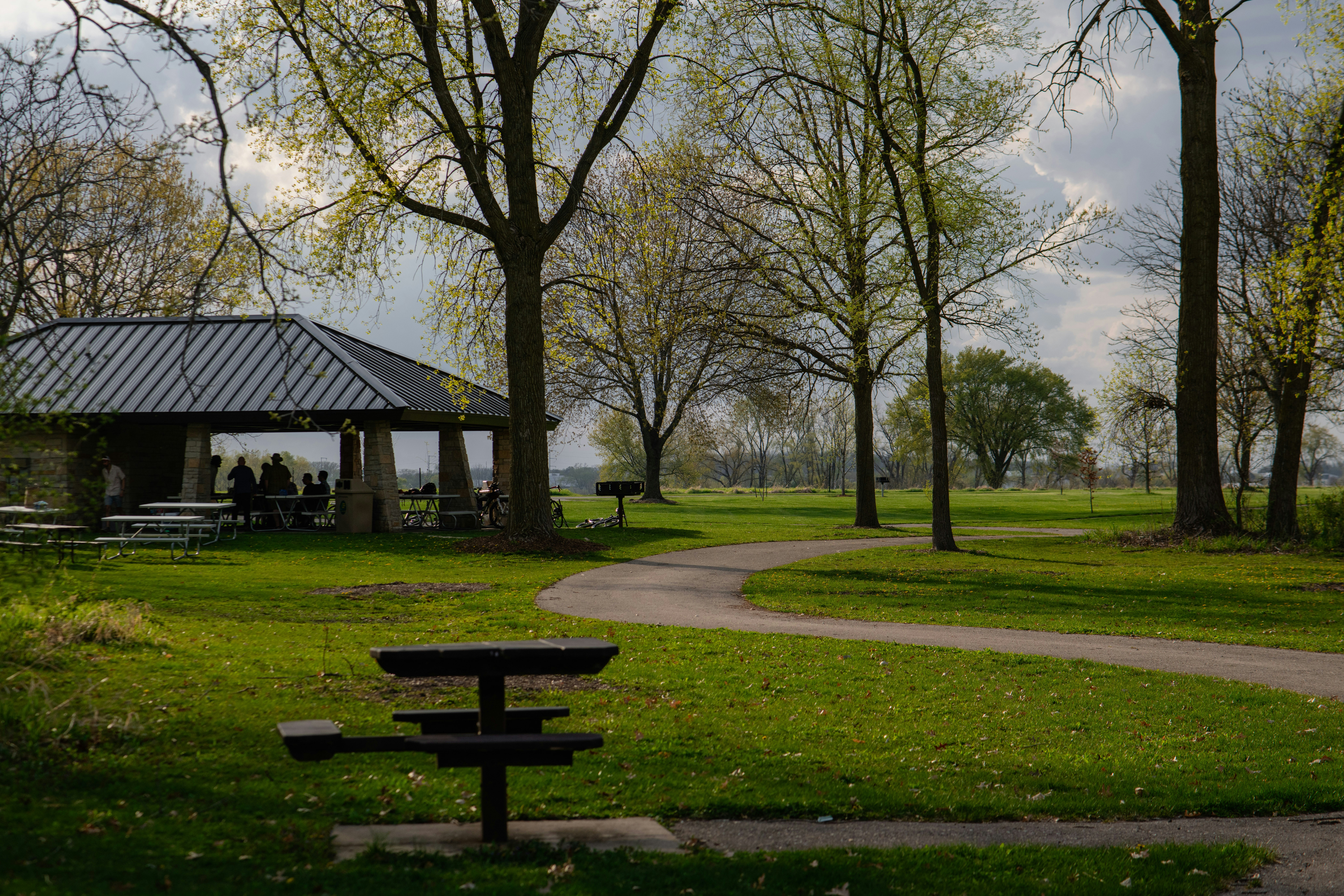 a park with a gazebo and picnic tables