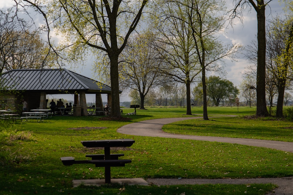 a park with a gazebo and picnic tables