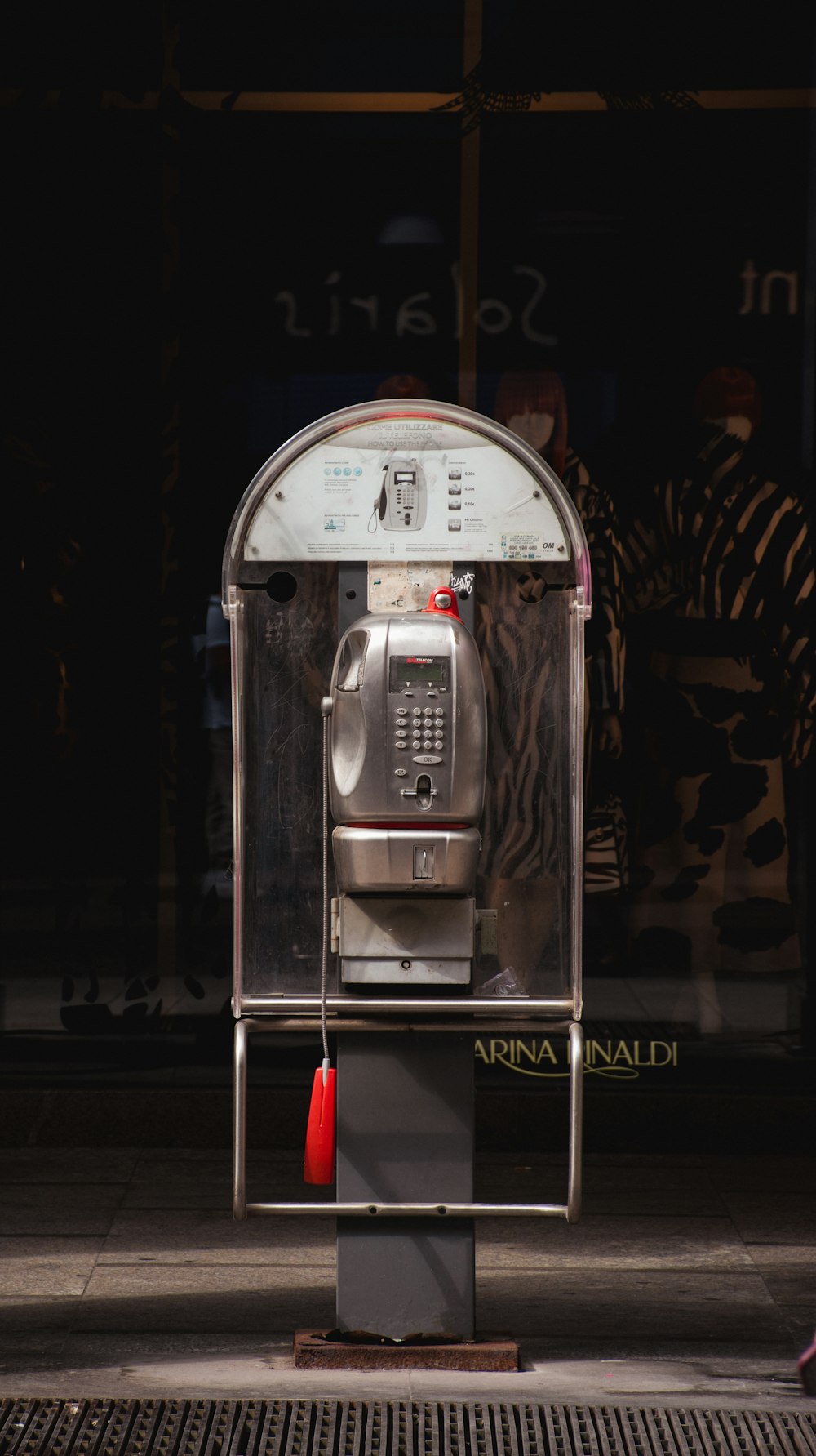 a parking meter sitting on the side of a street