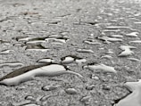 Clean sidewalk with water droplets reflecting sunlight after washing.