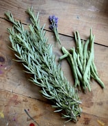 a bunch of herbs sitting on top of a wooden table