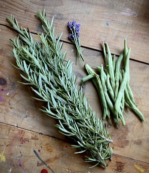 a bunch of herbs sitting on top of a wooden table