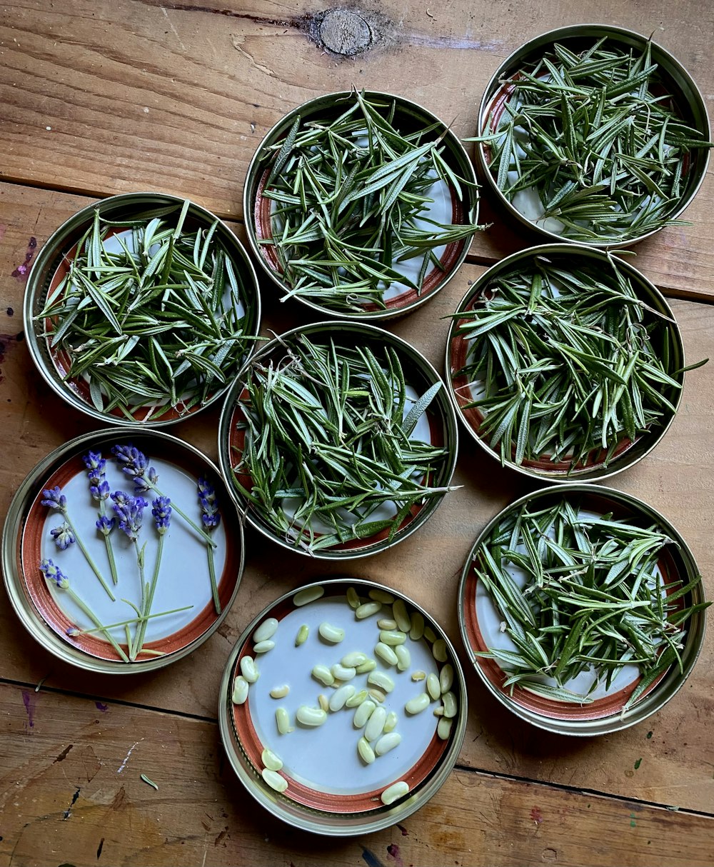 a table topped with bowls filled with plants