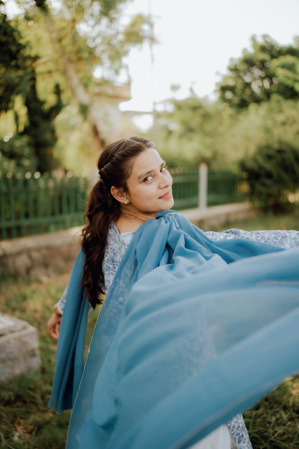 a woman with a blue scarf around her neck