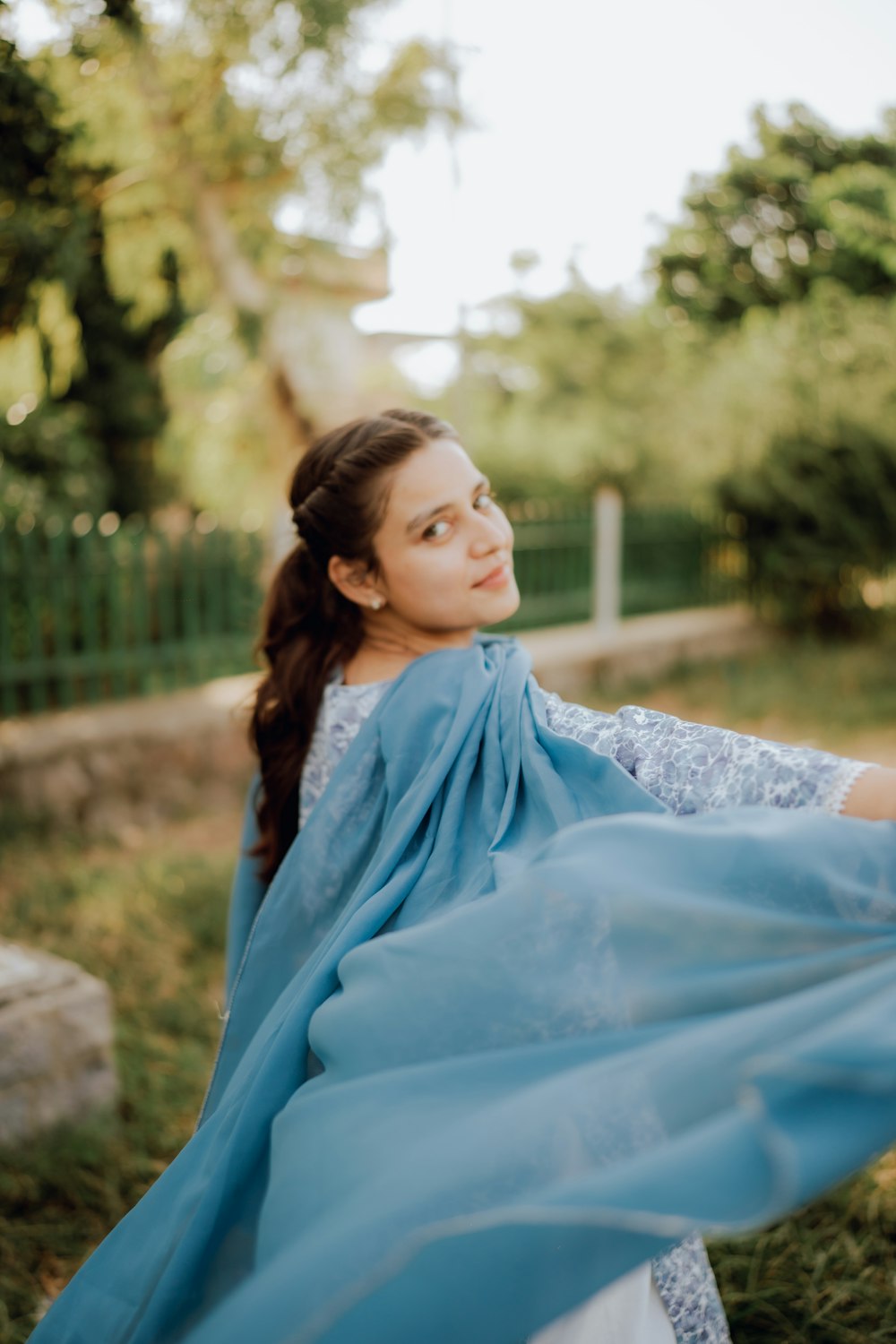 a woman with a blue scarf around her neck