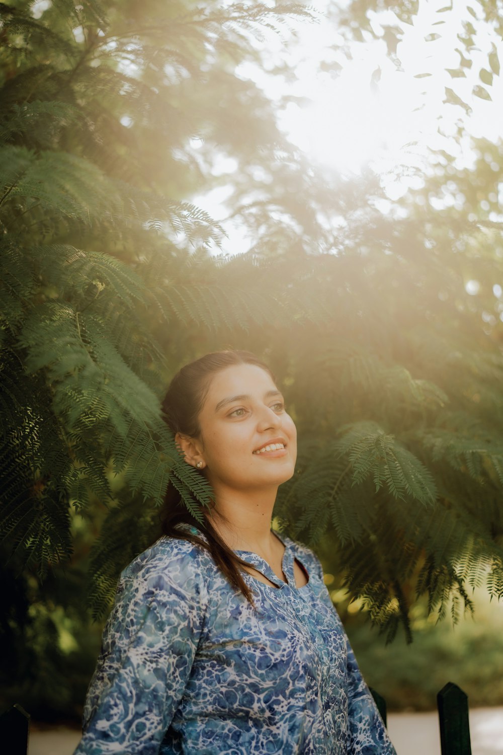 a woman standing in front of a tree