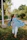 A cheerful little girl twirling in a colorful kurti from Zurish, outdoors on a sunny day.
