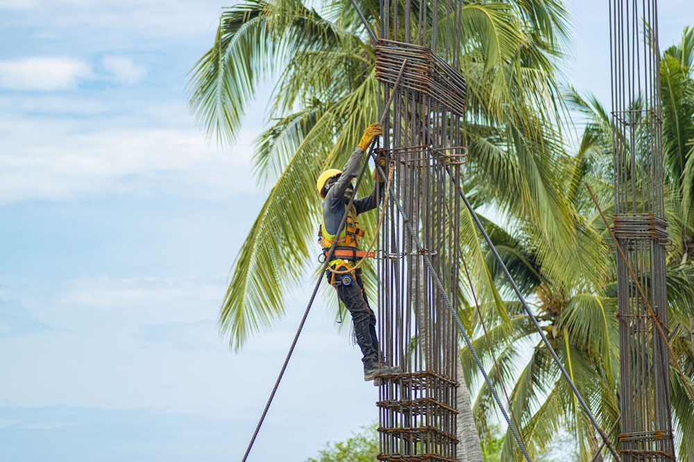 a man is climbing up a tall tower