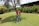 A satisfied customer standing in their newly landscaped yard.
