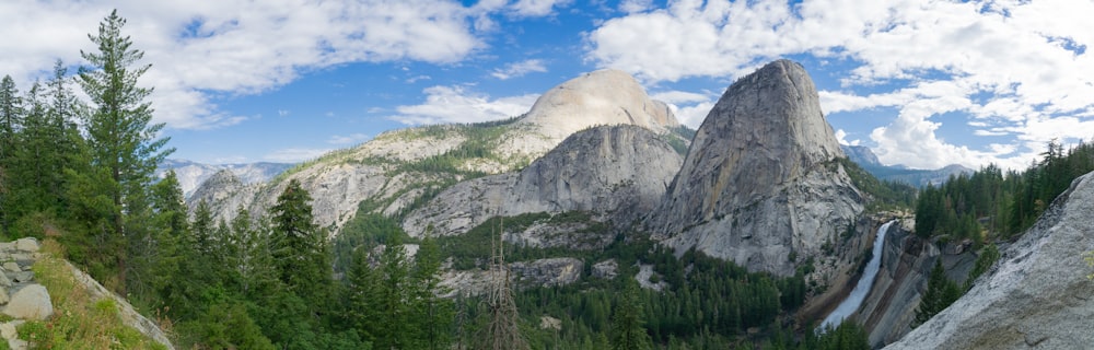 a scenic view of a mountain with a waterfall