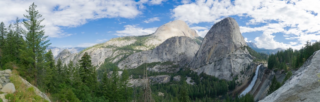 a scenic view of a mountain with a waterfall,