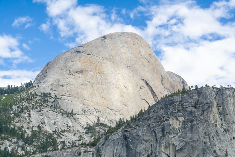 a mountain with a large rock face in the background