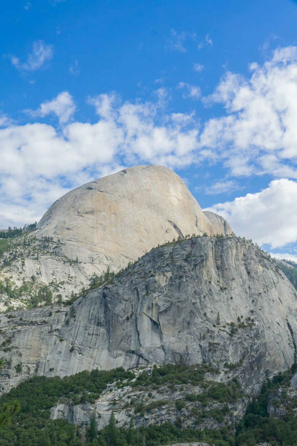 a mountain with a large rock face in the background