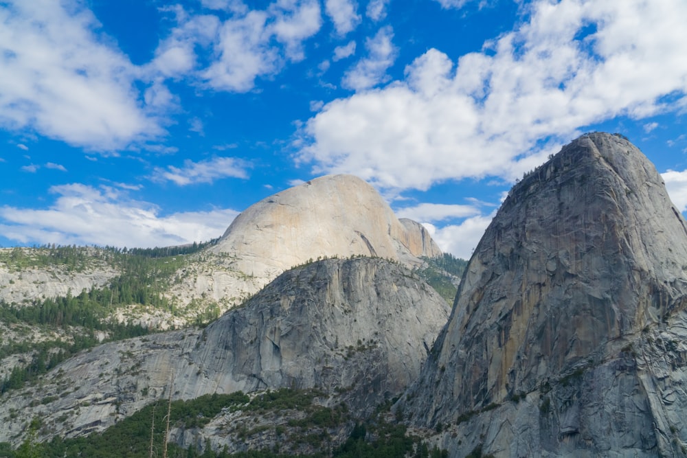 a view of a mountain range with clouds in the sky