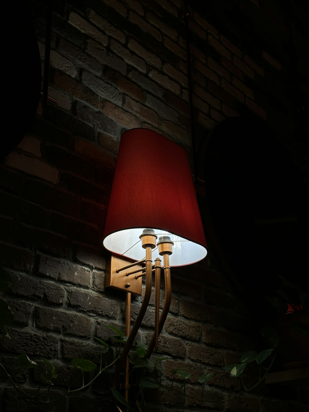 a lamp that is on a brick wall