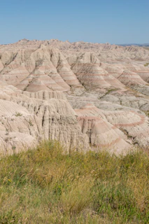 Visitors exploring colorful badlands with layered rock formations