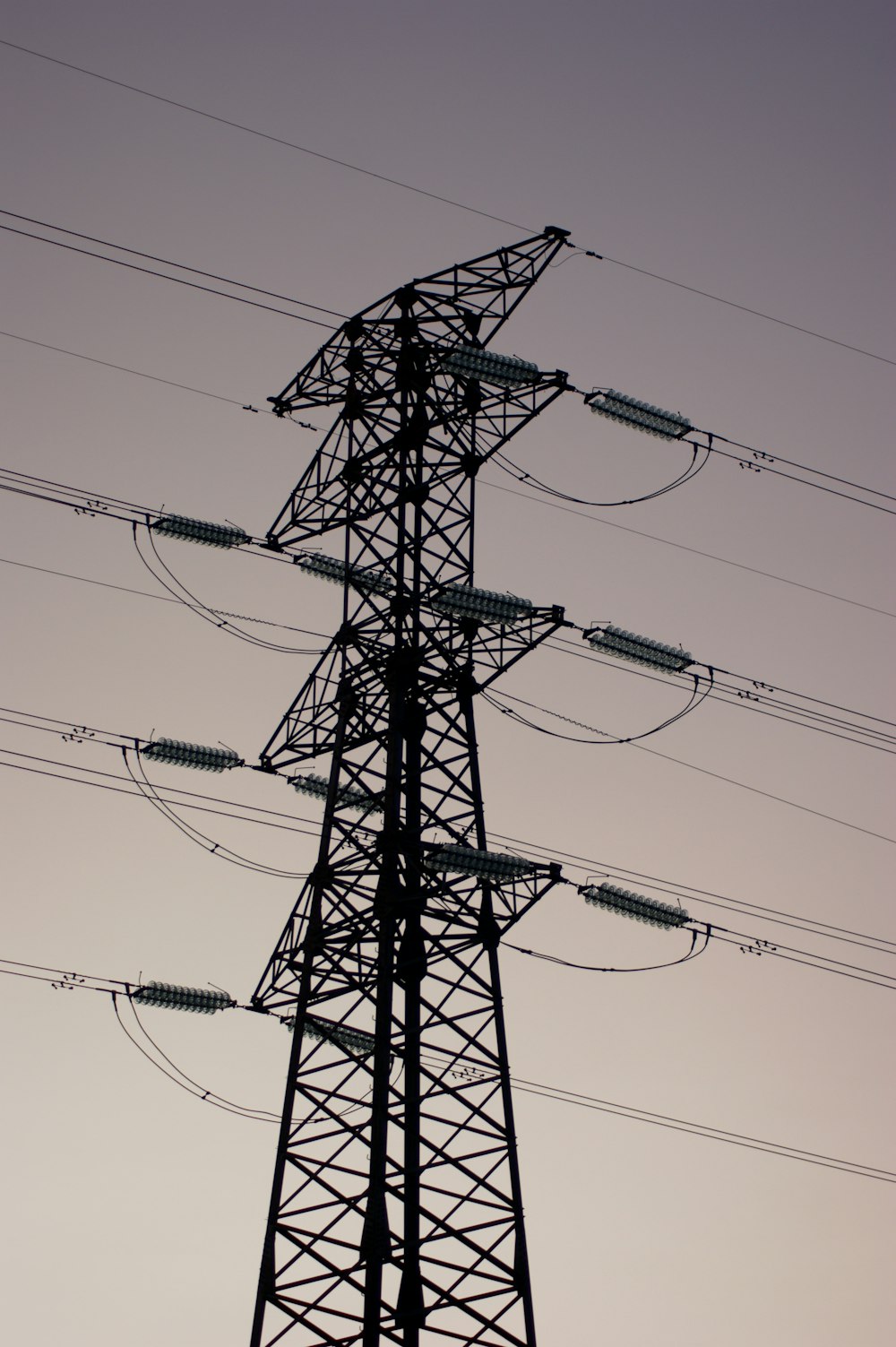 a tall tower with lots of power lines above it