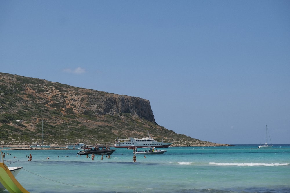 a group of boats floating on top of a body of water