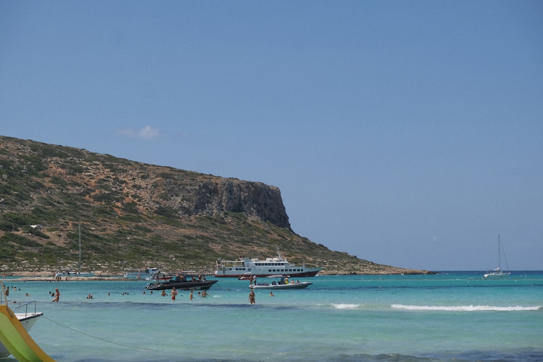 a group of boats floating on top of a body of water,